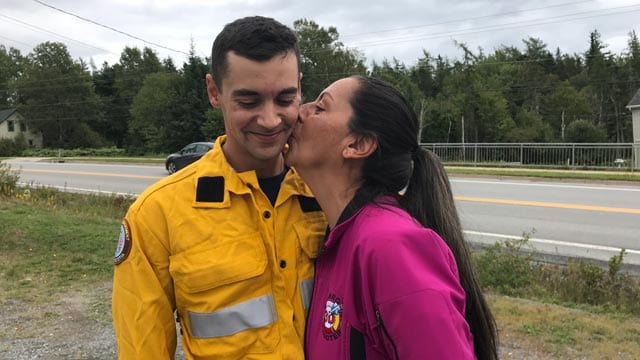 Shelley Falkenham plants a big kiss on the cheek of her son Gary. He's a newly minted firefighter who received his firefighting credentials in Nova Scotia and was off the next day to help fight the wildfires in British Columbia. In his community of ?? he's a hero. "I just love him," says Shelley. (Photo: Angel Moore/APTN)