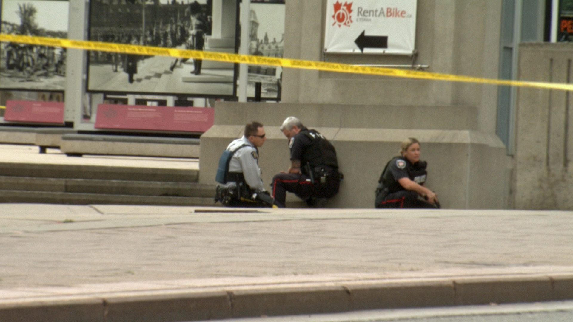Police take cover in downtown Ottawa following the shooting death of a Canadian solider.