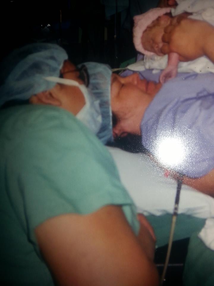 Father Sakoietah gazes at his new daughter Ieweras held by morther Darlene Gray.