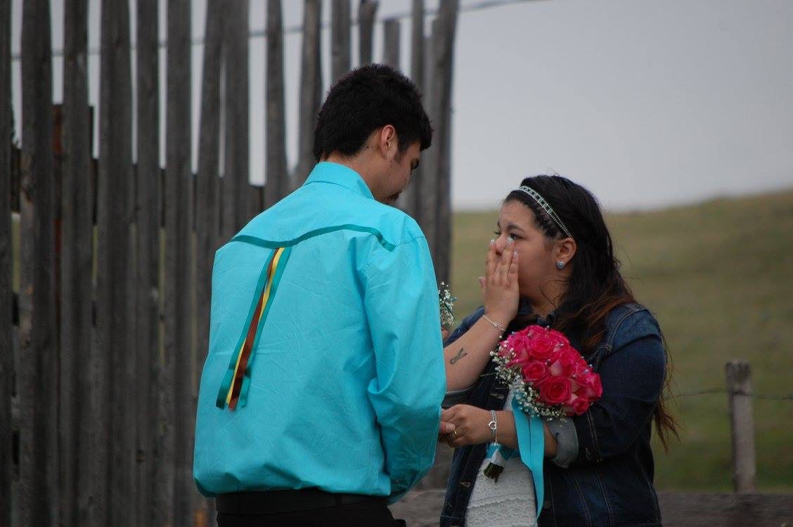 Courtney Carry wipes away a tear as Joseph Carry slides the ring on her finger. (photo courtesy of the family)