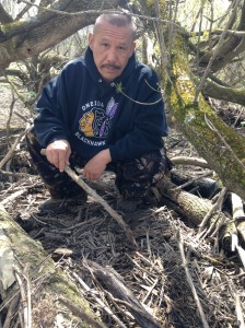 Anthony Nicholas points to a needle found in the flood plains of the Thames River along the Oneida Nation of the Thames Territory. The community has found dozens of needles they say washed up from London, some 20 km up river.