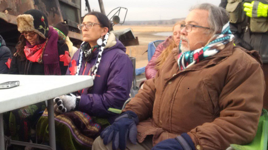 Robert “Black Eagle” Costa, foreground, held another veteran, an Elder, in his arms and felt him begin to die.  APTN/Photo