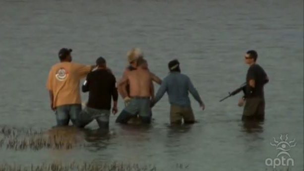 Kyle Thompson, right, confronts water protectors on Oct. 27. Brennon Nastacio is wearing the fur hat. APTN video still