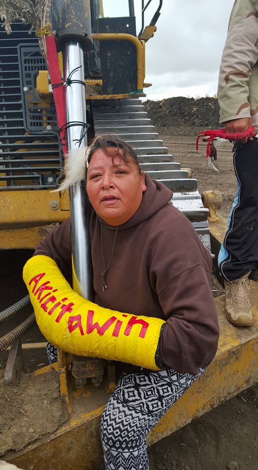 Julie Richards, an Oglala Lakota warrior, fastens herself to construction equipment Tuesday. Red Warrior Camp/Facebook